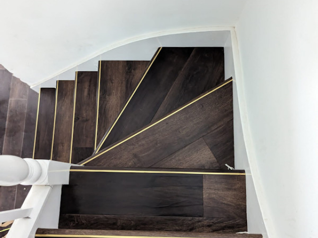 Luxury vinyl tiles fitted onto the tread and nosing of the stairs